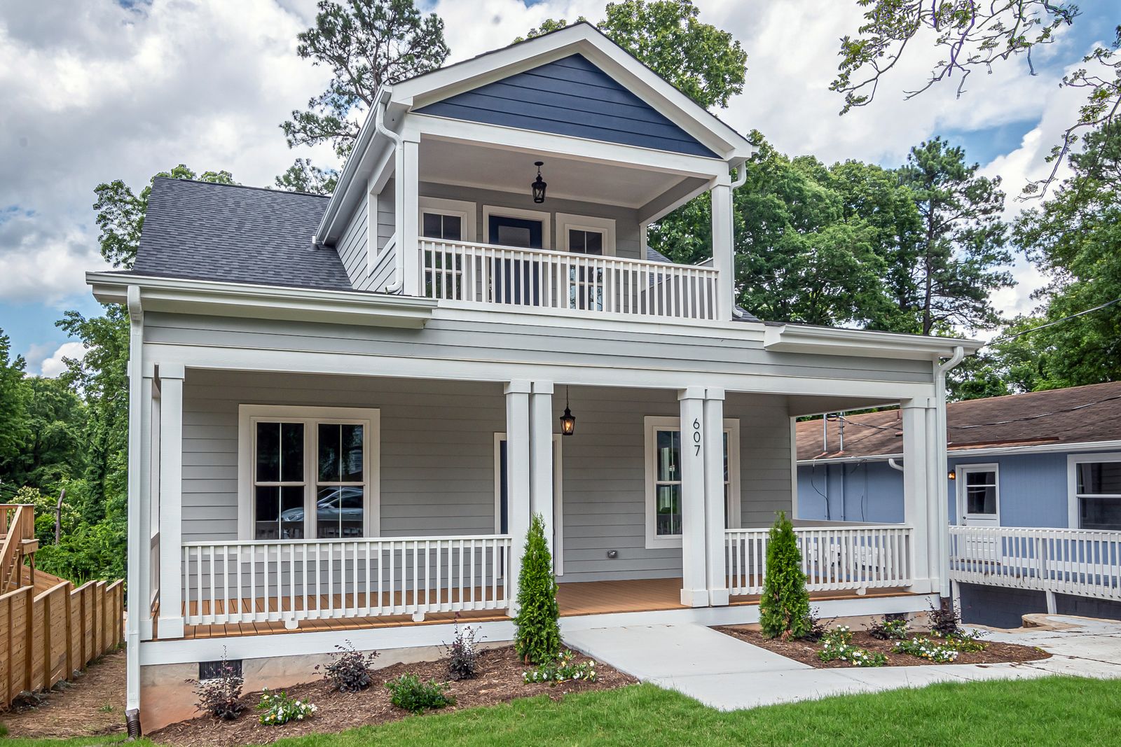 A two-story house with navy siding and white trim